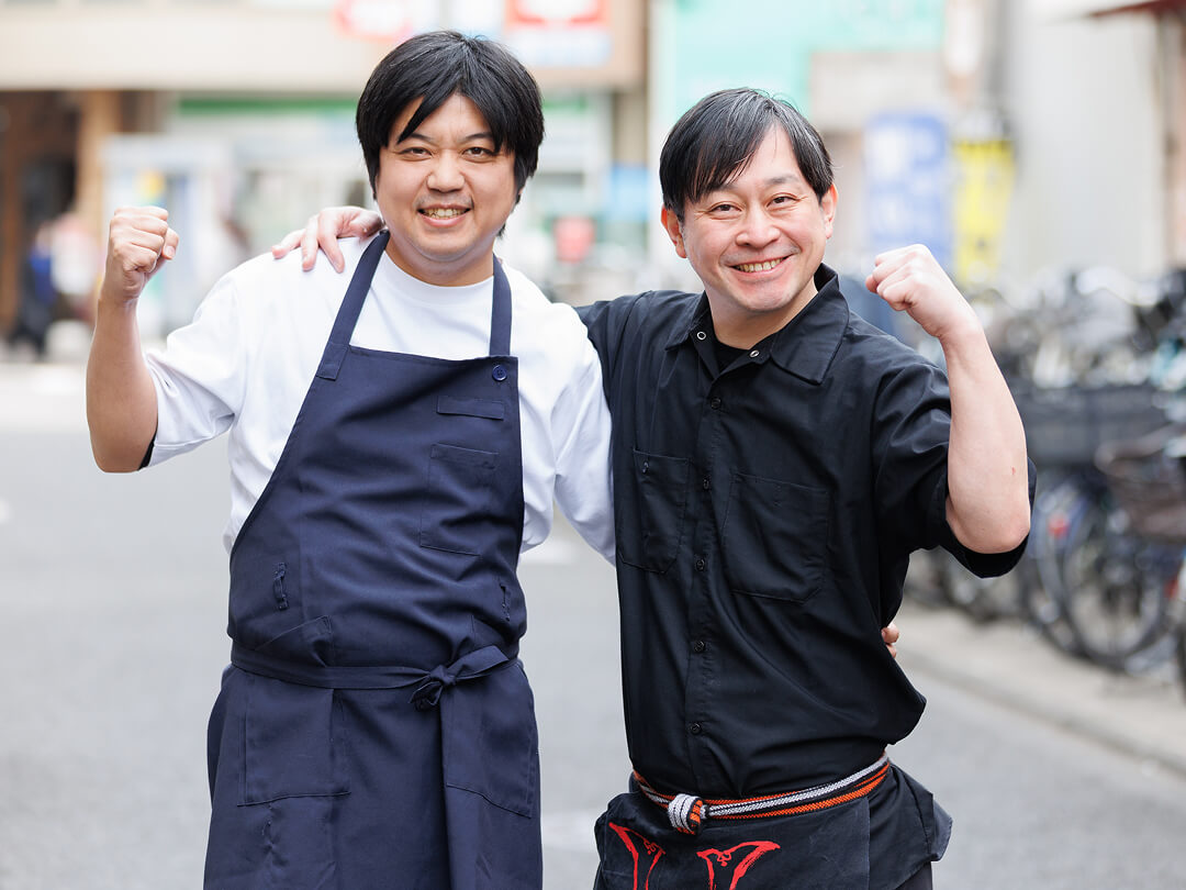 公私に薫陶を得る、つづらお町田店店長 守口(右)と肩を組んでポーズをとっている写真